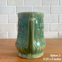 Load image into Gallery viewer, Antique vintage art deco gloss green Rosella 320 ceramic yellow ware pitcher featuring climbing roses on a basketweave pattern. Crafted by Robinson Clay Product Company, the precursor to Robinson Ransbottom Pottery, USA, early 1900s. A beautiful piece to add to your art pottery collection! Option 2, 5 1/4 x 5 inches
In as found vintage condition, no chips/repairs, tiny cracks at the spout, age-related crazing. Typical manufacturing glaze pops. Unmarked.