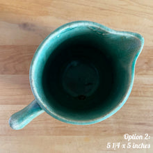Load image into Gallery viewer, Antique vintage art deco gloss green Rosella 320 ceramic yellow ware pitcher featuring climbing roses on a basketweave pattern. Crafted by Robinson Clay Product Company, the precursor to Robinson Ransbottom Pottery, USA, early 1900s. A beautiful piece to add to your art pottery collection! Option 2, 5 1/4 x 5 inches
In as found vintage condition, no chips/repairs, tiny cracks at the spout, age-related crazing. Typical manufacturing glaze pops. Unmarked.