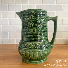 Load image into Gallery viewer, Antique vintage art deco gloss green Rosella 320 ceramic yellow ware pitcher featuring climbing roses on a basketweave pattern. Crafted by Robinson Clay Product Company, the precursor to Robinson Ransbottom Pottery, USA, early 1900s. A beautiful piece to add to your art pottery collection! Option 5, 6 1/2 x 7 1/2 inches
In as found vintage condition, no cracks/repairs, chips to handle, age-related crazing and large manufacturing glaze pops. Maker's marks.