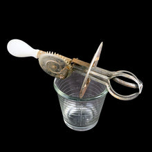 Load image into Gallery viewer, Vintage A&J clear depression era glass 1 pint (2 cup) hand beater mixer with white wood handle. The glass cup has measuring lines in 1/2 cup increments up to the 1 cup line and 1/4 cup increments up to the 2 cup line and the reverse in 2 ounce increments. Crafted by Hazel-Atlas Glass, circa 1920s. Perfect for beating eggs or mixing salad dressings.
In as found vintage condition, with wear.
