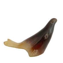 Load image into Gallery viewer, This charming vintage hand-carved sea lion sculpture is crafted from polished buffalo horn, showcasing beautiful natural color variations from deep black to translucent ivory. The minimalist folk art style, smooth contours, and subtle carved details give this piece a warm, tactile character that feels both playful and timeless.
Each angle highlights the artisan’s hand—no two horn carvings are ever exactly alike. A lovely addition to a coastal décor display, folk art collection, or curio shelf.