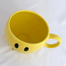 Load image into Gallery viewer, Bring on the happy with this vintage smiley face mug. Produced by Teleflora Gift, China. This one is a bit unusual as it has a spot to insert a stick into the smile, to hold balloons or a small sign perhaps. In excellent condition, free from chips/cracks/repairs. Looks like it's barely been used. Measures 4 1/4 x 4 1/8 inches Capacity 20 ounces