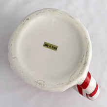 Load image into Gallery viewer, A hand painted vintage happy Santa Claus ceramic mug decorated in red, white, green and black plus a candy cane striped handle! Crafted in Taiwan, circa 1980s. Add charm to your Christmas decor by filling this adorable mug with candy canes! In excellent vintage condition, free from chips/cracks/repairs with one minor spot of glaze loss on the green holly leaf. Measures 3 1/2 x 3 1/4 inches