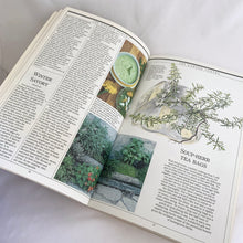 Load image into Gallery viewer, Vintage The Harrowsmith Illustrated Book of Herbs softcover 175-page reference book is jam-packed with detailed information on cultivating and using herbs. Written by Patrick Lima and beautifully illustrated by Turid Forsyth for Camden House, Canada, 1986, fourth printing 1990. A superior reference book for the herb and gardening enthusiast! In excellent vintage condition, minor yellowing to the interior pages.