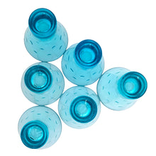 Load image into Gallery viewer, Base view of 6 Hazel-Atlas Capri Dots turquoise whisky glasses showing the base and dot texture, glasses arranged in a scattered diagonal layout