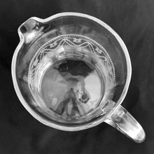 Load image into Gallery viewer, Overhead view of rim and needle-etched Trefoil tatting pattern on Heisey No. 3350 pitcher — sawtooth border, swag drapes, and floral bow motifs