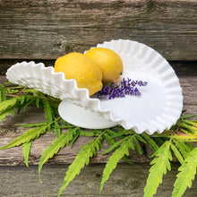 Load image into Gallery viewer, This vintage "Hobnail" pressed milk glass low banana stand brings all the drama! It features a low foot, with folded sides and a crimped edge. Crafted by the Fenton Art Glass, USA, circa 1970s. A graceful piece of pressed glass in a classic pattern that will always be in style no matter your decor style. Fill with your favourite fruits and display! In excellent condition, free form chips/cracks. Measures 12 x 9 x 4 1/2 inches