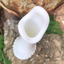 Load image into Gallery viewer, This vintage milk glass "Hobnail" handled swung bud vase brings all the drama in a small package! Crafted by the Fenton Art Glass, USA, circa 1960s. A graceful piece of mold blown and hand pulled glass in a classic pattern that will always be in style no matter your decor style! In excellent condition, free form chips/cracks. Measures 2 1/2 x 9 1/8 inches