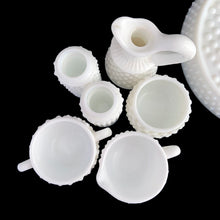 Load image into Gallery viewer, This rare vintage "Hobnail" milk glass condiment set features a round tray with silver-toned handle, salt and pepper shakers, cruet with stopper, creamer, open sugar and jam pot. A classic piece of American glass history to add to your collection! In overall excellent condition for a set of this age. Absent from this set are the lid and spoon for the jam pot. The lid on one of the shakers has damage in one spot where the chrome finish has come away (see photos).