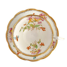 Load image into Gallery viewer, Vintage bone china Avon shaped "Honeysuckles" teacup and saucer. Each piece has a lovely scalloped edge featuring a hand painted Honeysuckle vines and bees in shades of orange, pink, yellow, blue and green, trimmed with gold gilt. Crafted by Royal Albert, England, circa 1927 to 1935. Makes a beautiful gift or addition to your collection!