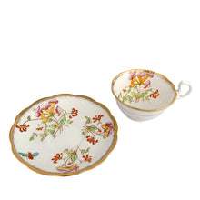 Load image into Gallery viewer, Vintage bone china Avon shaped "Honeysuckles" teacup and saucer. Each piece has a lovely scalloped edge featuring a hand painted Honeysuckle vines and bees in shades of orange, pink, yellow, blue and green, trimmed with gold gilt. Crafted by Royal Albert, England, circa 1927 to 1935. Makes a beautiful gift or addition to your collection!