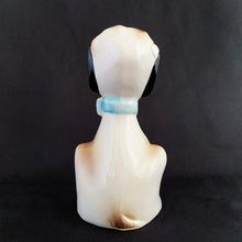 Load image into Gallery viewer, Show off the playful charm of this adorably freckle faced ceramic hound dog figurine! Its wide-eyed expression and pink tongue will add a dash of fun to any room. This beige, tan and black canine features a classic blue bow tie and is sure to charm everyone who sees it! In excellent condition, free form chips/cracks/repairs. Marked "Japan" on the bottom. Measures 2 x 4 1/2 inches