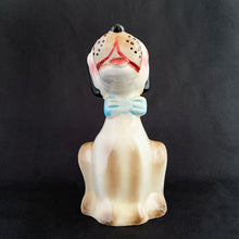 Load image into Gallery viewer, Show off the playful charm of this adorably freckle faced ceramic hound dog figurine! Its wide-eyed expression and pink tongue will add a dash of fun to any room. This beige, tan and black canine features a classic blue bow tie and is sure to charm everyone who sees it! In excellent condition, free form chips/cracks/repairs. Marked "Japan" on the bottom. Measures 2 x 4 1/2 inches