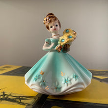 Load image into Gallery viewer, This sweet vintage mid-century figurine is one of the Birthday of the Month series designed by Josef Originals of Japan, circa 1950s. This sweet girl is beautifully styled wearing a full length dress hand painted in aqua and gold, holding a basket of yellow flowers with an aquamarine birthstone in the centre of each flower. In excellent condition, free from chips/cracks/repairs. Marked on the bottom "Josef Originals © Japan" Measures 3 1/2 x 4 inches