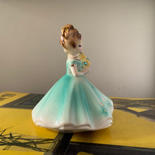 Load image into Gallery viewer, This sweet vintage mid-century figurine is one of the Birthday of the Month series designed by Josef Originals of Japan, circa 1950s. This sweet girl is beautifully styled wearing a full length dress hand painted in aqua and gold, holding a basket of yellow flowers with an aquamarine birthstone in the centre of each flower. In excellent condition, free from chips/cracks/repairs. Marked on the bottom "Josef Originals © Japan" Measures 3 1/2 x 4 inches