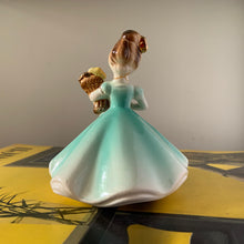Load image into Gallery viewer, This sweet vintage mid-century figurine is one of the Birthday of the Month series designed by Josef Originals of Japan, circa 1950s. This sweet girl is beautifully styled wearing a full length dress hand painted in aqua and gold, holding a basket of yellow flowers with an aquamarine birthstone in the centre of each flower. In excellent condition, free from chips/cracks/repairs. Marked on the bottom "Josef Originals © Japan" Measures 3 1/2 x 4 inches