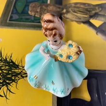 Load image into Gallery viewer, This sweet vintage mid-century figurine is one of the Birthday of the Month series designed by Josef Originals of Japan, circa 1950s. This sweet girl is beautifully styled wearing a full length dress hand painted in aqua and gold, holding a basket of yellow flowers with an aquamarine birthstone in the centre of each flower. In excellent condition, free from chips/cracks/repairs. Marked on the bottom "Josef Originals © Japan" Measures 3 1/2 x 4 inches