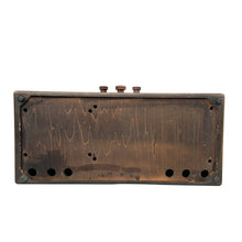 Load image into Gallery viewer, Underside of wooden radio cabinet showing mounting holes, circular cutouts and four corner feet