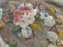 Load image into Gallery viewer, Detail of a pale pink needlepoint rose with small blue flowers, green leaves and visible stitch texture beneath glass