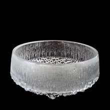 Load image into Gallery viewer, Three-quarter view of Iittala Ultima Thule clear glass footed serving bowl highlighting ice-bark surface texture and organic bubble foot detail