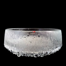 Load image into Gallery viewer, Front view of Iittala Ultima Thule clear glass footed serving bowl showing vertical ice-bark texture, bubble foot ring, and original red Iittala Made in Finland label
