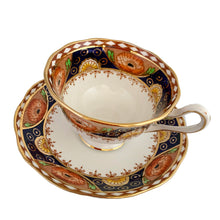 Load image into Gallery viewer, Vintage bone china Avon shaped Imari-style teacup and saucer, "Un-Named Set #562". Each piece has a lovely scalloped edge featuring hand painted cobalt blue panels inset with orange poppy and yellow daisy flowers, topped by a band of white diamonds, trimmed with gold gilt. Crafted by Royal Albert, England, 1930s. Makes a beautiful gift or addition to your collection!