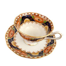 Load image into Gallery viewer, Vintage bone china Avon shaped Imari-style teacup and saucer, "Un-Named Set #562". Each piece has a lovely scalloped edge featuring hand painted cobalt blue panels inset with orange poppy and yellow daisy flowers, topped by a band of white diamonds, trimmed with gold gilt. Crafted by Royal Albert, England, 1930s. Makes a beautiful gift or addition to your collection!
