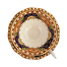 Load image into Gallery viewer, Vintage bone china Avon shaped Imari-style teacup and saucer, "Un-Named Set #562". Each piece has a lovely scalloped edge featuring hand painted cobalt blue panels inset with orange poppy and yellow daisy flowers, topped by a band of white diamonds, trimmed with gold gilt. Crafted by Royal Albert, England, 1930s. Makes a beautiful gift or addition to your collection!