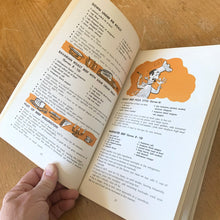 Load image into Gallery viewer, This vintage softcover It's Mainly Because of the Meat Cookbook. There are 145 pages with recipes and colour illustrations and photography. Dominion Stores, Canada, 1969. A handy guide to bring your favourite foods to life!
In excellent vintage condition, appears unused. Age-related foxing/yellowing of the pages.
Measurements 5 3/4 x 9 inches