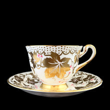 Load image into Gallery viewer, A gorgeous white bone china teacup and saucer featuring gold gilt ivy leaves and trim with pink berries florals. Crafted by Royal Chelsea, England, 1940s. A lovely addition to any china collection!
In excellent vintage condition, no chips, cracks or repairs.
Teacup measures 3 1/2 x 2 5/8 inches
Saucer measures 5 1/2 inches