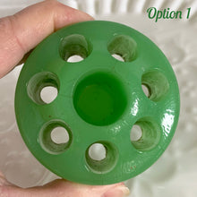 Load image into Gallery viewer, Jadeite green glass flower frog held in hand, top-down view showing holes