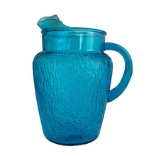 Load image into Gallery viewer, A selection of vintage mid-century modern "Pagoda" glass beverage pitcher in striking laser blue. Crafted by Anchor Hocking, USA, circa 1960s. This glassware features a unique bark-like texture and is the perfect addition to your Tiki or Chinoiserie style drink and barware! All pieces are excellent condition, free from chips.