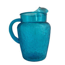 Load image into Gallery viewer, A selection of vintage mid-century modern "Pagoda" glass beverage pitcher in striking laser blue. Crafted by Anchor Hocking, USA, circa 1960s. This glassware features a unique bark-like texture and is the perfect addition to your Tiki or Chinoiserie style drink and barware! All pieces are excellent condition, free from chips.