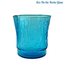 Load image into Gallery viewer, A selection of vintage mid-century modern "Pagoda" glass tumblers in striking laser blue. Crafted by Anchor Hocking, USA, circa 1960s. This glassware features a unique bark-like texture and is the perfect addition to your Tiki or Chinoiserie style drink and barware! All pieces are excellent condition, free from chips. 8oz On the Rocks Glass