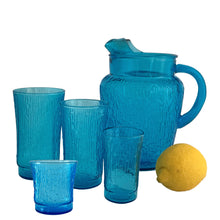 Load image into Gallery viewer, A selection of vintage mid-century modern "Pagoda" glass tumbler sets and pitcher in striking laser blue. Crafted by Anchor Hocking, USA, circa 1960s. This glassware features a unique bark-like texture and is the perfect addition to your Tiki or Chinoiserie style drink and barware! All pieces are excellent condition, free from chips.