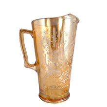 Load image into Gallery viewer, Gorgeous vintage mid century era iridescent marigold carnival glass pitcher featuring the "Late Sunflowers" pattern of wildflowers and ferns in white. Crafted by Jeannette Glass, USA, 1950s. The perfect way to serve your favourite beverage with vintage flare! In excellent condition, minor wear. Flea bites along the mold release at the interior rim, see photos. Measures 5 5/8 x 9 5/8 inches Capacity 56 ounces