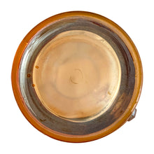 Load image into Gallery viewer, Gorgeous vintage mid century era iridescent marigold carnival glass pitcher featuring the "Late Sunflowers" pattern of wildflowers and ferns in white. Crafted by Jeannette Glass, USA, 1950s. The perfect way to serve your favourite beverage with vintage flare! In excellent condition, minor wear. Flea bites along the mold release at the interior rim, see photos. Measures 5 5/8 x 9 5/8 inches Capacity 56 ounces