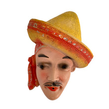 Load image into Gallery viewer, Charming and scarce, this vintage chalkware wall hung string holder featuring a handsome Latin American man wearing a red and yellow sombrero and scarf was a pleasure to find in such amazing condition! Dates to the 1940s. A wonderfully decorative piece! In excellent vintage condition with minor wear to the paint, no chips/cracks/repairs. Measures 6 1/4 x 2 3/4 x 7 3/8 inches