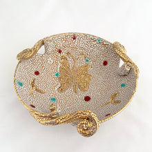 Load image into Gallery viewer, A fabulous piece of Bitossi mid-century lava pebble glazed pottery dish featuring a gold butterfly and three decorative scrolled and curled handles. Artisan crafted in Italy, and imported to North America by Irving Richards of Raymor, USA, circa 1960s. Makes a lovely trinket or candy dish. A phenomenal gift for the MCM lover. Excellent condition, free from chips/cracks/repairs. Marked Italy. Measures 6 1/2 x 2 3/8 inches