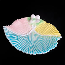 Load image into Gallery viewer, Lovely vintage ceramic leaf shaped dish in pastel colours of pink, yellow, blue and green with white figural fruits. Italy, circa 1960s. Use for your favourite snacks, trinkets or as a catchall. Adds a nice pop of colour to your decor!  In excellent condition with one small flea bite on the rim of the foot. Marked Italy.  Measures 9 1/2 x 7 x 2 inches