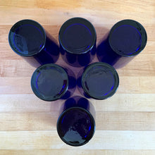 Load image into Gallery viewer, Base view of six vintage Libbey Flare cobalt blue tumblers showing smooth flat bottoms and maker's mark