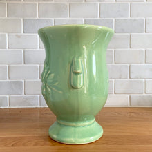 Load image into Gallery viewer, Side view of the light green vase showing the curved handle detail