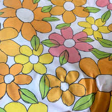 Load image into Gallery viewer, Bring back the flower power of the 1960s with this vintage doulbe/full sized "Light and Lively" floral fitted bed sheet. The bright flowers of this pattern are featured in orange, pink and yellow with green leaves outlined in black on a white background. In excellent condition, free from tears. Elastic is nice and stretchy. Measures 54 x 75 inches with a 7 1/2 inch drop.