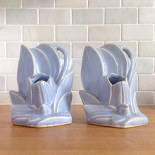 Load image into Gallery viewer, Striking vintage matte lilac water lily bookends. Crafted by Nelson McCoy Pottery, 1940s. These rare bookends are a must for any McCoy art pottery collector!
In as found vintage condition, with a couple of chips, see photos. Maker's marks on both pieces.
Measures 6 1/4 x 5 1/2 inches