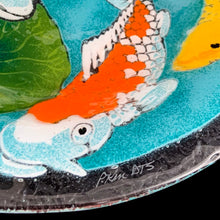 Load image into Gallery viewer, Exquisite vintage fused art glass bowl, featuring a colourful pond scene with vibrant Koi fish and elegant water lilies. Designed by talented artisan Peggy Karr who operated one of the USA's premier fused glass studios from 1987 - 2016. Whether for serving or as home decor, this vivid colour palette adds a burst of energy to any space, making it a must-have for every art lover! In excellent condition, free from chips. Signed by the artist. Measures 13 x 2 1/2 inches