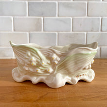 Load image into Gallery viewer, Vintage "Lily of the Valley" Parian porcelain candy dish with embossed blossoms and foliage highlight with green lustre and gold gilt detail. Crafted by Belleek, Ireland, 1980 - 1992 (7th mark). A beautiful collector piece! In excellent condition, free from chips/cracks/repairs. Gold Mark Measures 5 3/4 x 2 3/4 x 2 1/2 inches