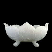 Load image into Gallery viewer, Vintage mid-Century "Lombardi" milk glass footed bowl was part of the Cameo Line of glassware, crafted by Jeanette Glass, USA, circa 1950s. A lovely design featuring swirls of leaves with a central cameo, flared scalloped edge and sweet curled feet. Perfect for candy, snacks or use as a serving bowl and even a planter! In excellent condition, free from chips. Measures 10 1/2 x 6 3/4 x 5 1/4 inches