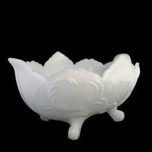Load image into Gallery viewer, Vintage mid-Century "Lombardi" milk glass footed bowl was part of the Cameo Line of glassware, crafted by Jeanette Glass, USA, circa 1950s. A lovely design featuring swirls of leaves with a central cameo, flared scalloped edge and sweet curled feet. Perfect for candy, snacks or use as a serving bowl and even a planter! In excellent condition, free from chips. Measures 10 1/2 x 6 3/4 x 5 1/4 inches