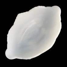 Load image into Gallery viewer, Vintage mid-Century "Lombardi" milk glass footed bowl was part of the Cameo Line of glassware, crafted by Jeanette Glass, USA, circa 1950s. A lovely design featuring swirls of leaves with a central cameo, flared scalloped edge and sweet curled feet. Perfect for candy, snacks or use as a serving bowl and even a planter! In excellent condition, free from chips. Measures 10 1/2 x 6 3/4 x 5 1/4 inches