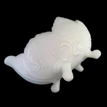 Load image into Gallery viewer, Vintage mid-Century "Lombardi" milk glass footed bowl was part of the Cameo Line of glassware, crafted by Jeanette Glass, USA, circa 1950s. A lovely design featuring swirls of leaves with a central cameo, flared scalloped edge and sweet curled feet. Perfect for candy, snacks or use as a serving bowl and even a planter! In excellent condition, free from chips. Measures 10 1/2 x 6 3/4 x 5 1/4 inches